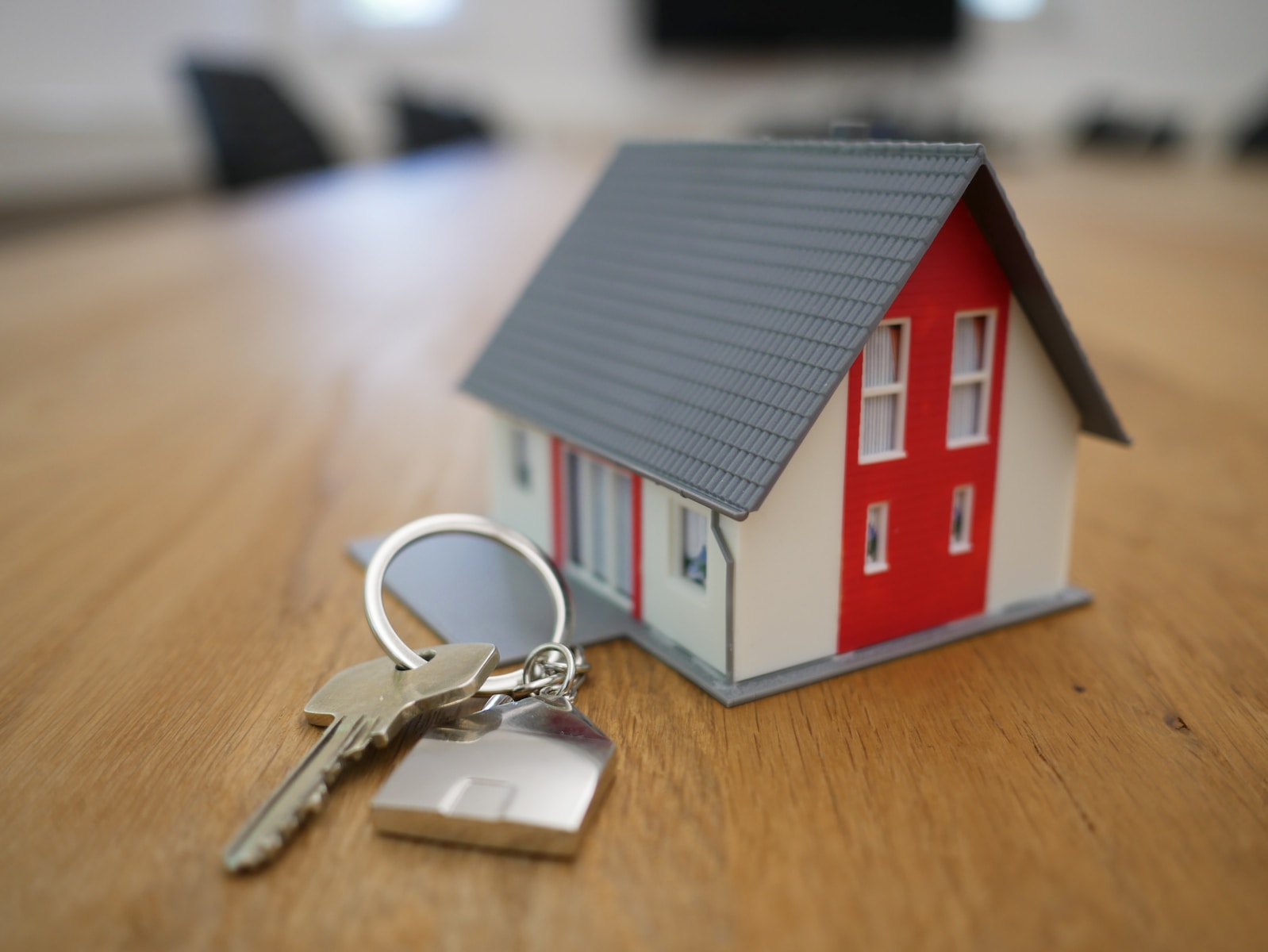 white and red wooden home miniature on brown table